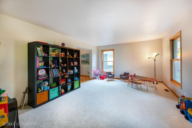 recreation room featuring carpet flooring and baseboards