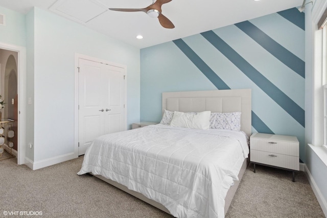 carpeted bedroom with a closet, baseboards, a ceiling fan, and recessed lighting