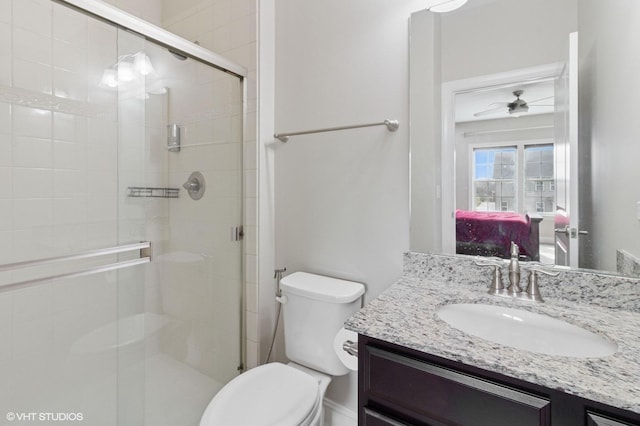 full bath with a shower stall, a ceiling fan, vanity, ensuite bath, and toilet