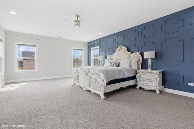 carpeted bedroom with baseboards and ceiling fan