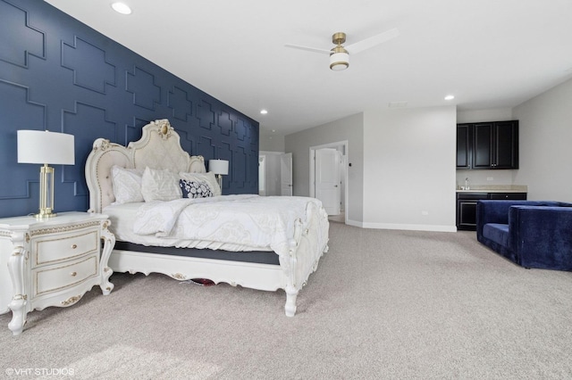 bedroom with bar, baseboards, light carpet, and recessed lighting