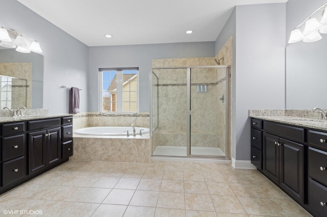 bathroom with tile patterned floors, a garden tub, a sink, and a stall shower