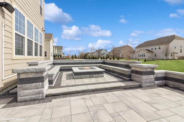 view of patio / terrace featuring a fire pit and a residential view