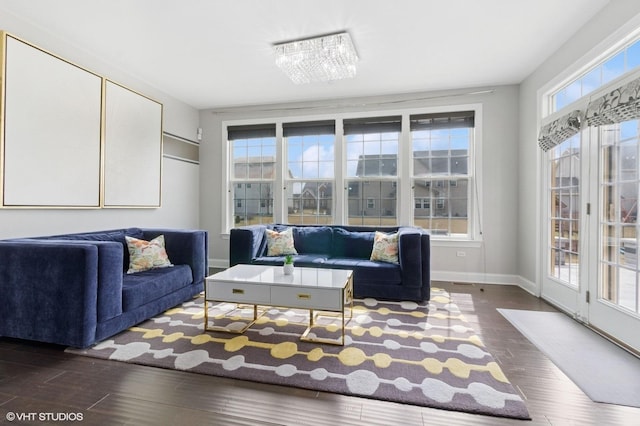 living room featuring baseboards and dark wood-style floors