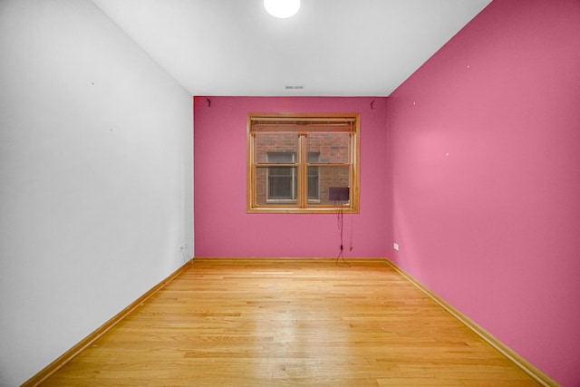 unfurnished room with light wood-type flooring, baseboards, and visible vents