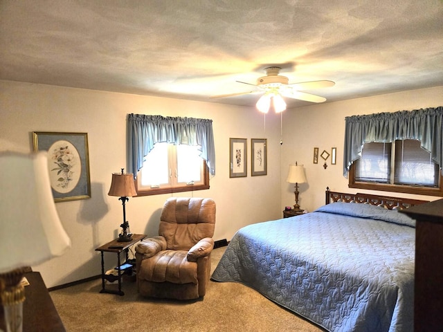 bedroom featuring baseboards, carpet floors, a textured ceiling, and a ceiling fan