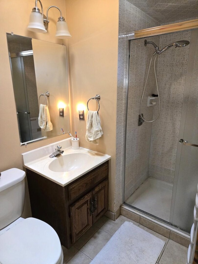 full bathroom with tile patterned flooring, toilet, vanity, and a shower stall