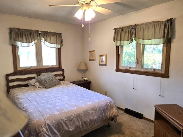 carpeted bedroom with a ceiling fan and baseboards