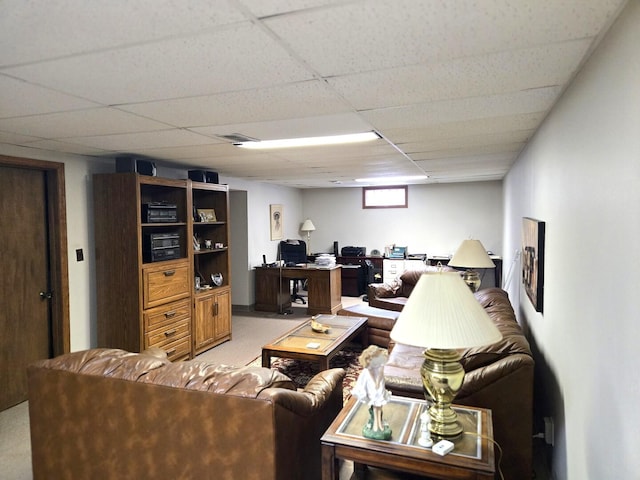 living area with light carpet and a paneled ceiling