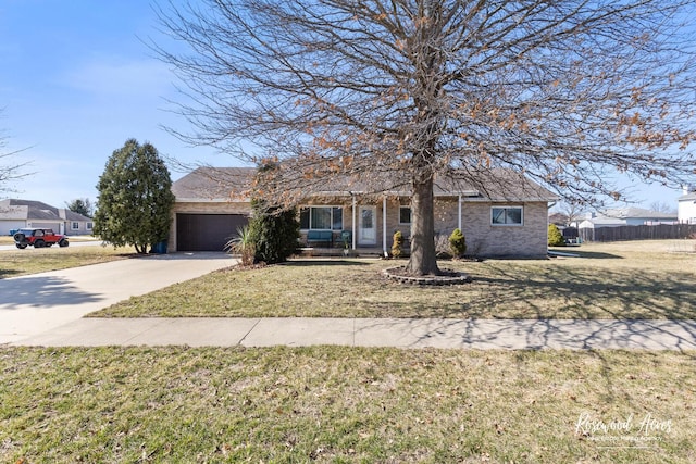 view of front of house featuring fence, an attached garage, concrete driveway, a front lawn, and brick siding