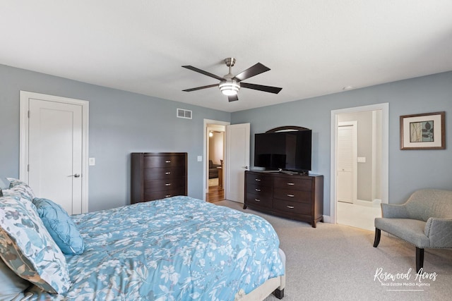 bedroom with a ceiling fan, visible vents, and light carpet