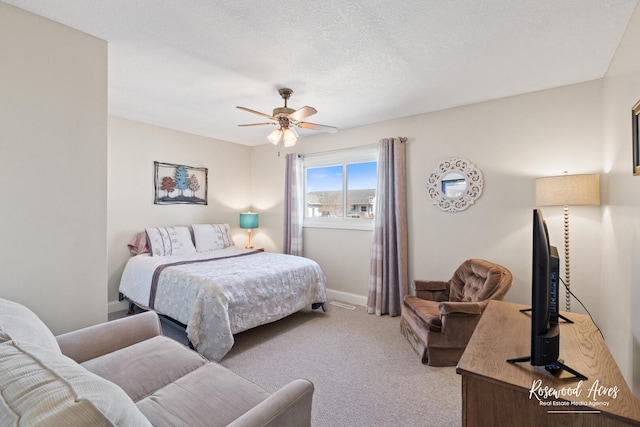 bedroom with baseboards, a textured ceiling, a ceiling fan, and carpet floors