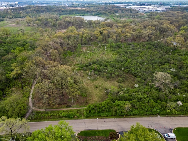 aerial view of property's location with a heavily wooded area and a large body of water