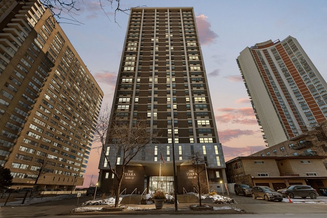 property at dusk featuring a city view