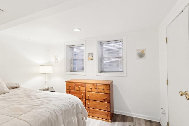 bedroom featuring recessed lighting, crown molding, baseboards, and wood finished floors