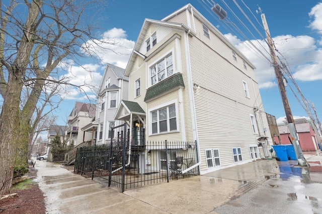 view of property exterior featuring a residential view and fence