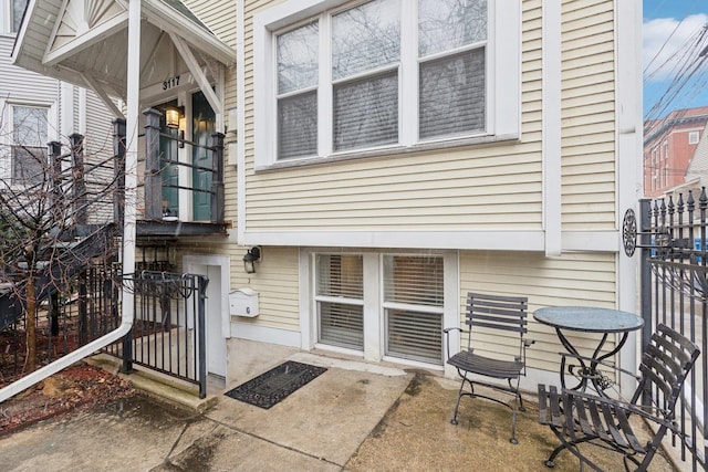 doorway to property featuring a patio area and fence