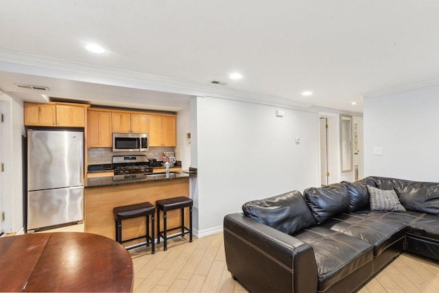 living room with recessed lighting, light wood-style floors, visible vents, and ornamental molding