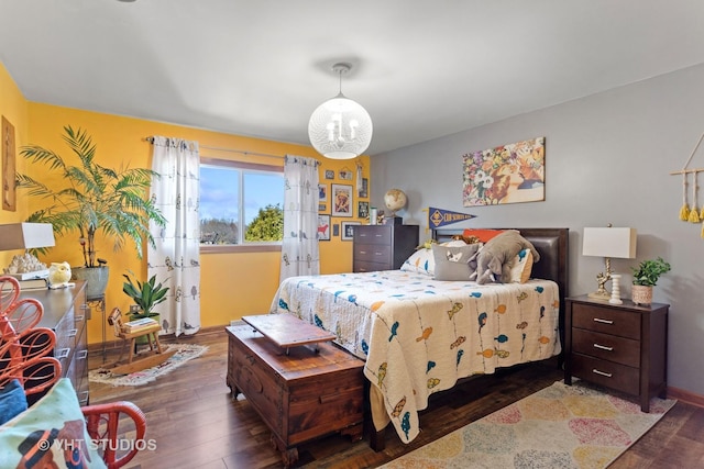 bedroom with baseboards and wood finished floors