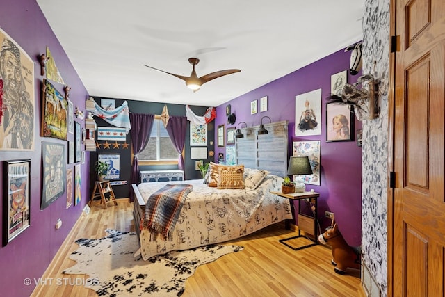 bedroom with light wood-style flooring and ceiling fan