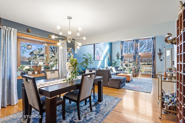 dining area with a notable chandelier and light wood-style floors