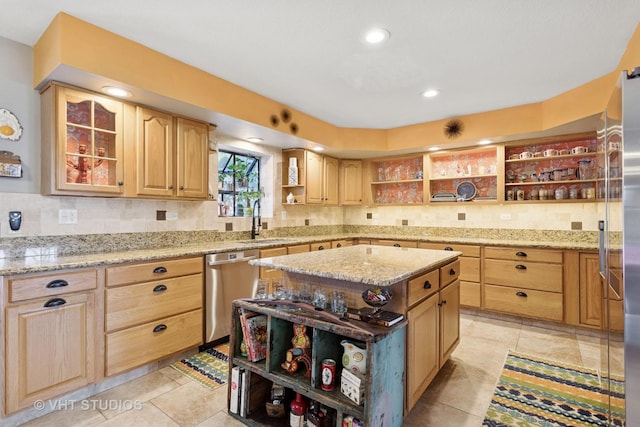 kitchen with light brown cabinets, open shelves, light stone counters, a sink, and dishwasher