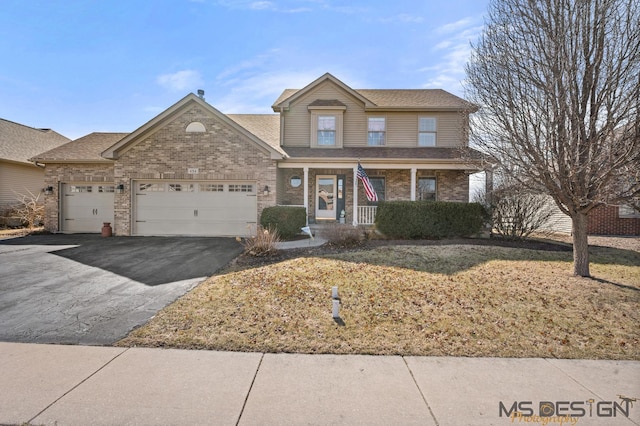 traditional-style home featuring aphalt driveway, brick siding, a garage, and a shingled roof