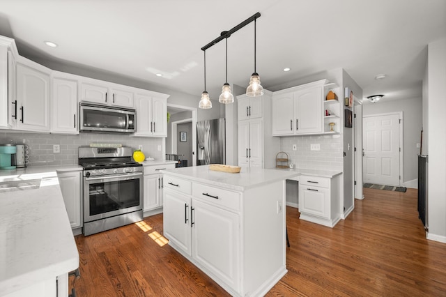 kitchen featuring open shelves, dark wood finished floors, a center island, appliances with stainless steel finishes, and white cabinets