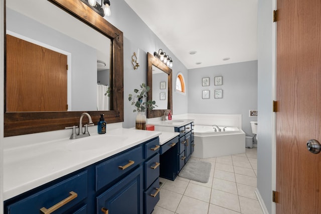 bathroom featuring a bath, vanity, and tile patterned flooring