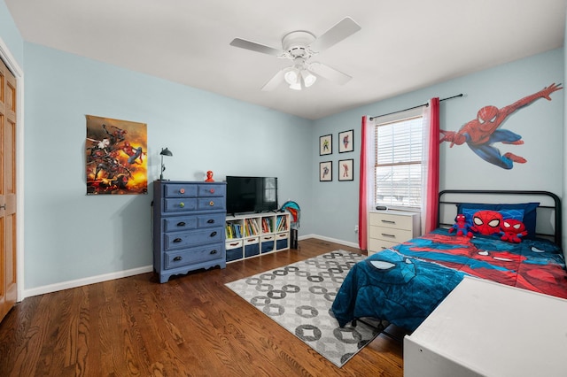 bedroom featuring wood finished floors, baseboards, and ceiling fan