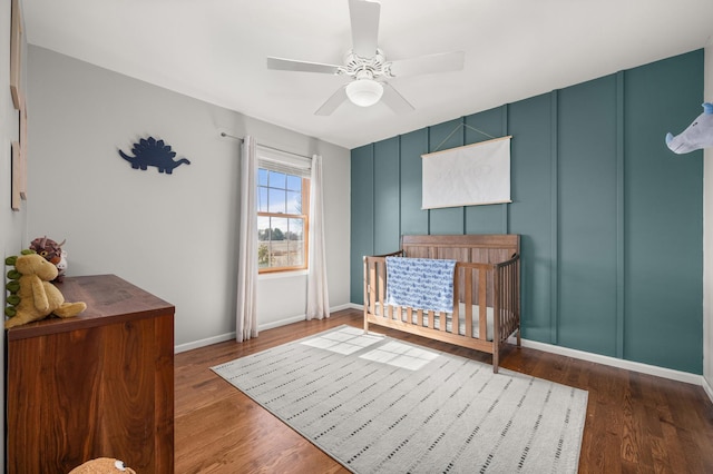 bedroom with wood finished floors and a decorative wall