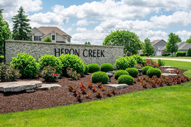 community / neighborhood sign with a lawn