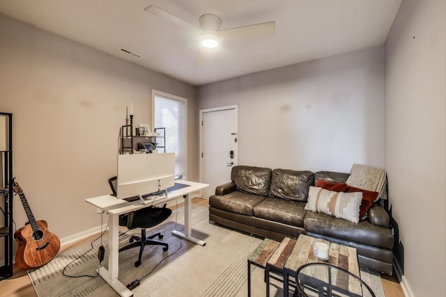 office area with visible vents, baseboards, a ceiling fan, and wood finished floors