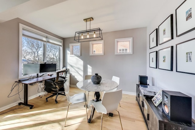 home office with light wood-style floors and baseboards