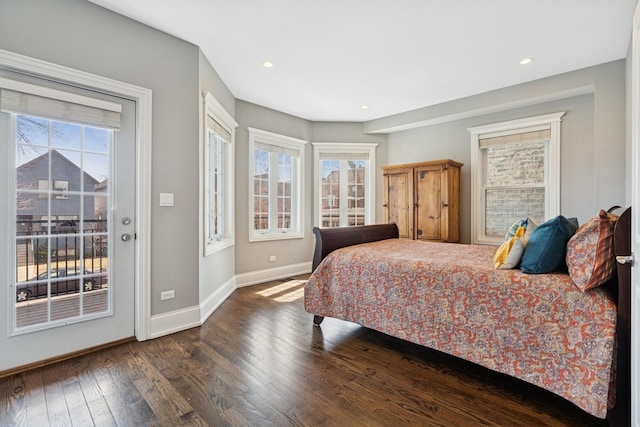 bedroom with access to exterior, multiple windows, baseboards, and hardwood / wood-style floors