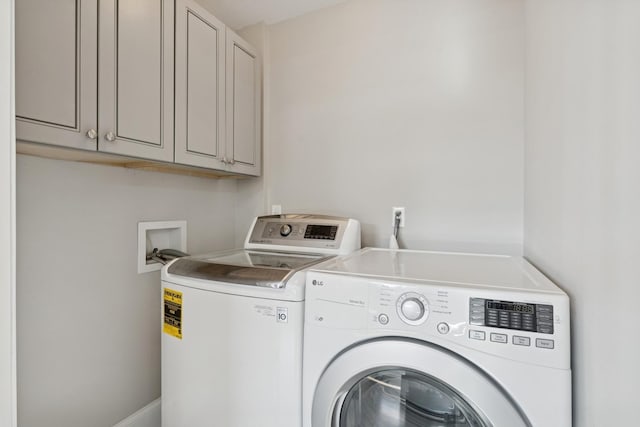 laundry area featuring cabinet space and separate washer and dryer