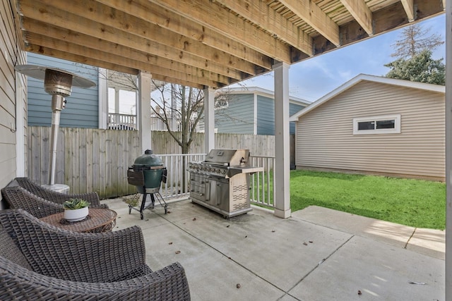 view of patio featuring an outdoor structure, area for grilling, and fence