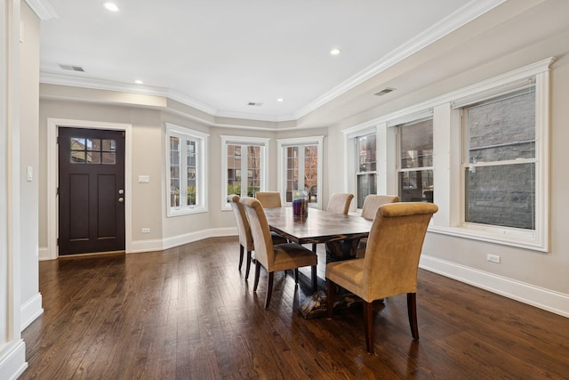 dining space with dark wood-style floors, visible vents, baseboards, and ornamental molding