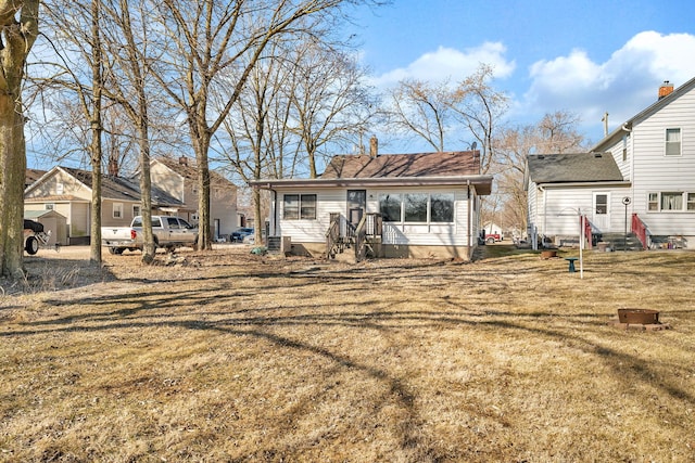 back of property featuring a yard