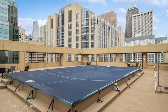 exterior space featuring a city view and carpet flooring