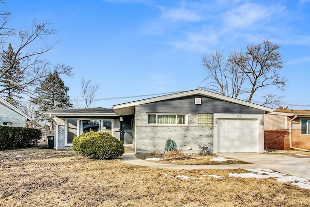 ranch-style home with brick siding, concrete driveway, and an attached garage