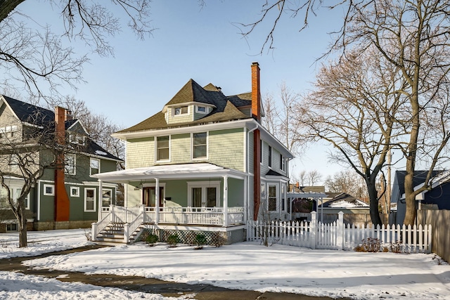 traditional style home featuring a pergola, a porch, a chimney, and fence