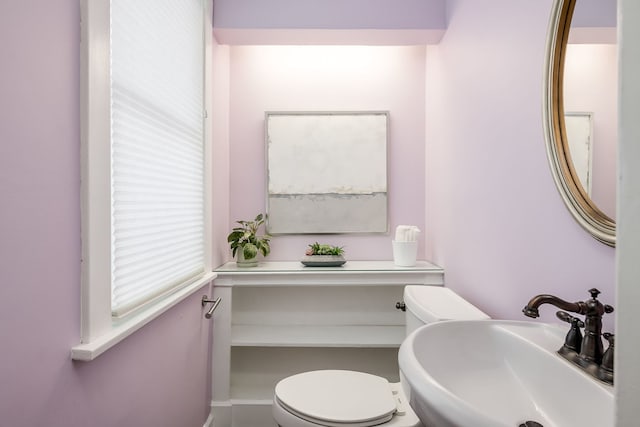 bathroom with toilet and a sink