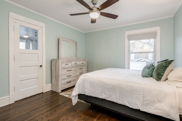 bedroom featuring a ceiling fan, wood finished floors, and crown molding