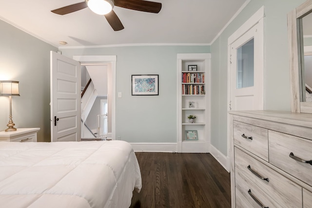 bedroom with dark wood finished floors, crown molding, baseboards, and ceiling fan