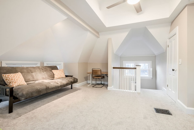 living area featuring carpet, visible vents, baseboards, ceiling fan, and vaulted ceiling