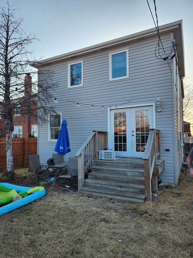 back of house featuring french doors and fence