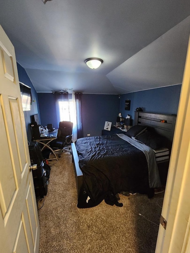 carpeted bedroom featuring lofted ceiling