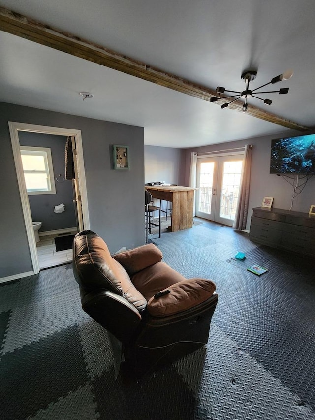 carpeted living area with a healthy amount of sunlight, french doors, and baseboards