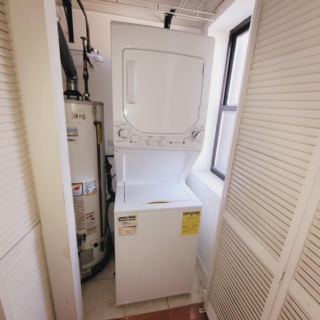 washroom with water heater, laundry area, and stacked washer and clothes dryer